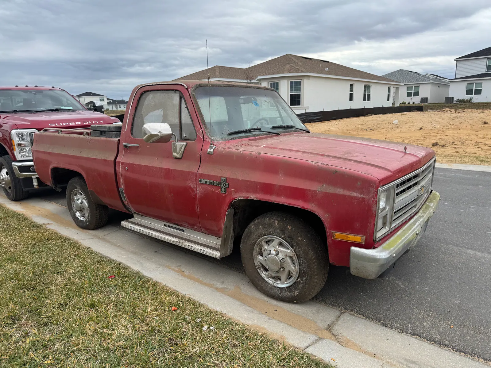 1986 Chevy C10 single cab short bed square-body truck bought for cash, parked at the curb in Florida