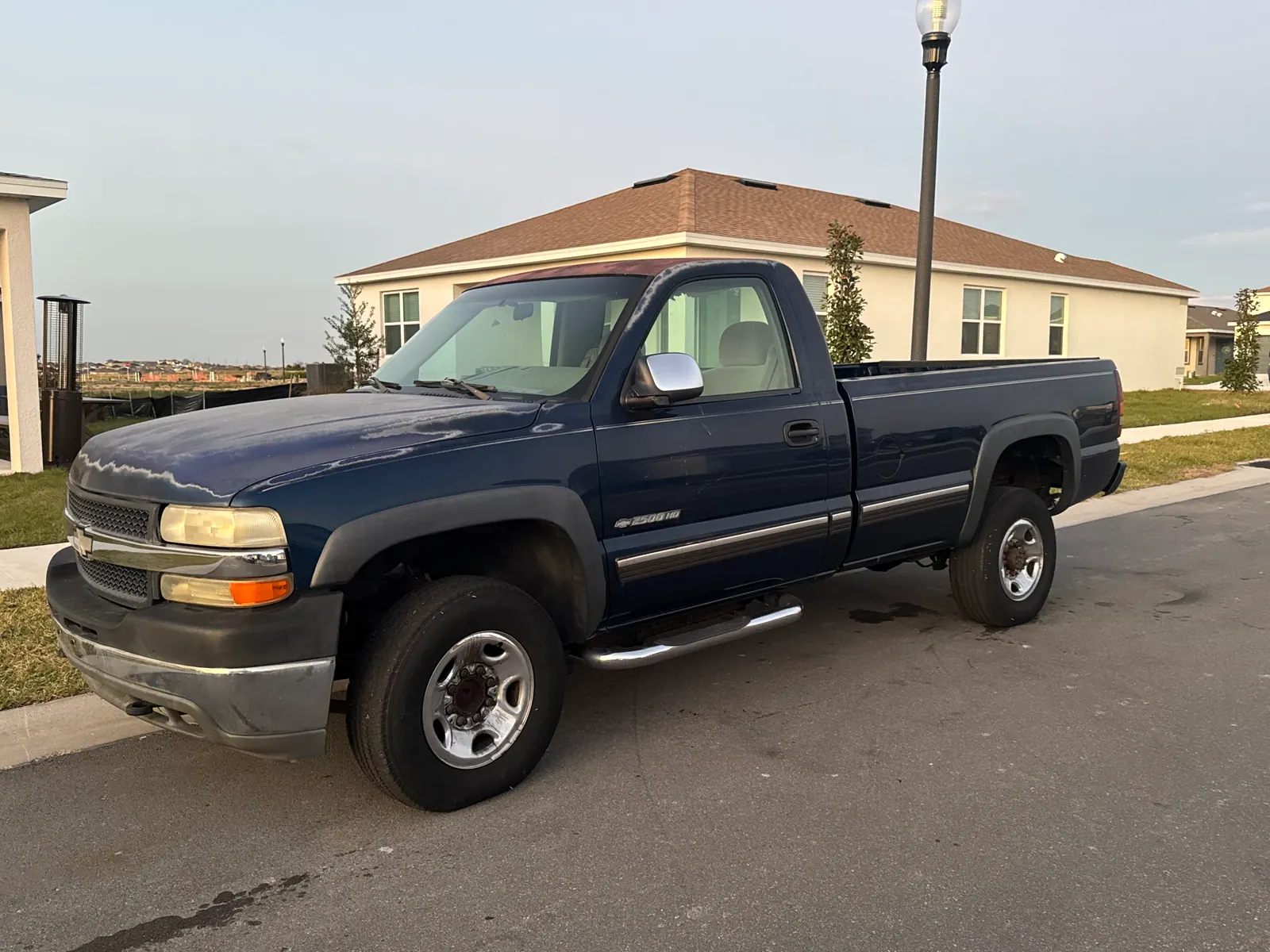 2003 Chevy 2500HD with peeling clear coat bought for cash in a Florida neighborhood